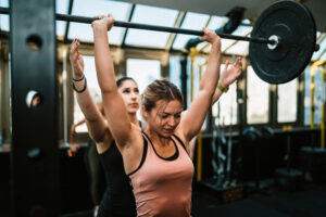 two women lifting weights